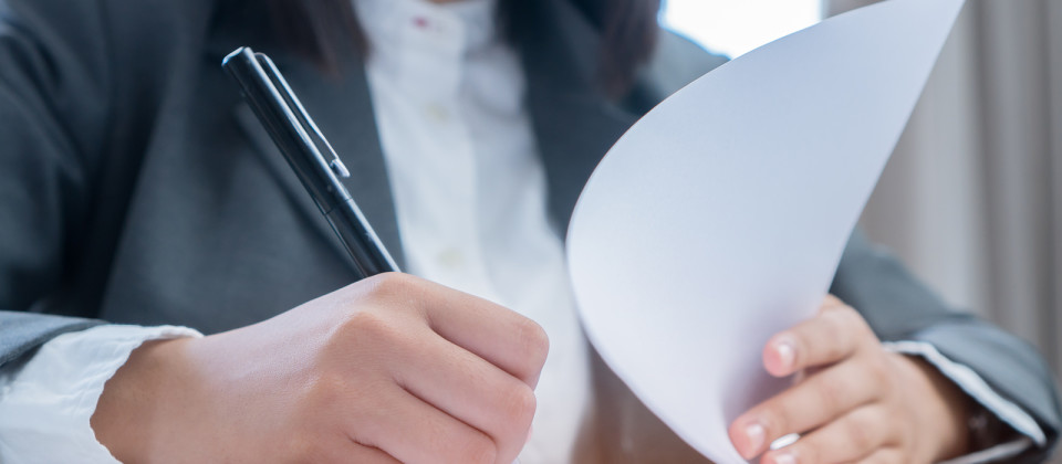 Asian Business Woman Manager Checking And Signing Applicant Fill